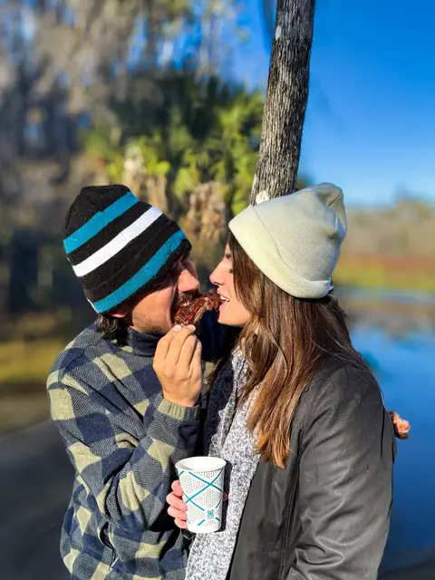 Couple sharing smoked ribs at an outdoor Florida event